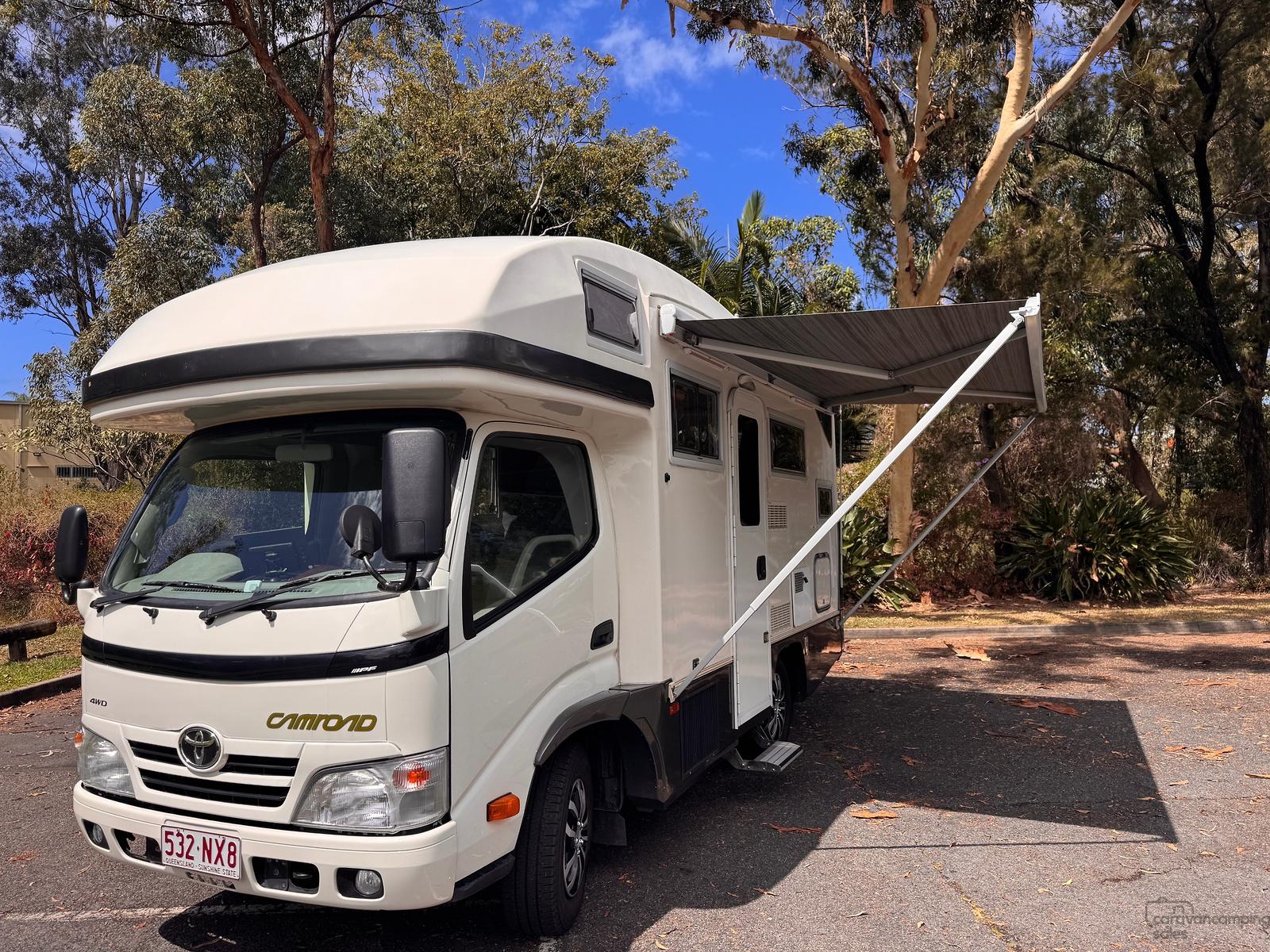 The seller’s Toyota Camroad viewed from the front with its awning extended